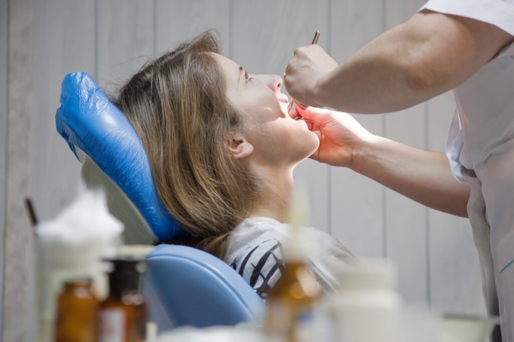 Dental hygienist performing a professional teeth cleaning in an East York clinic