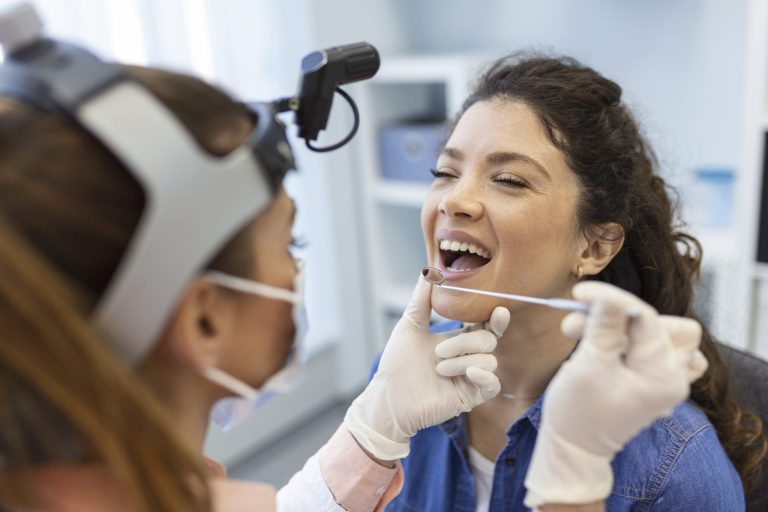 Relaxed patient laughing with her dentist during a calm dental visit